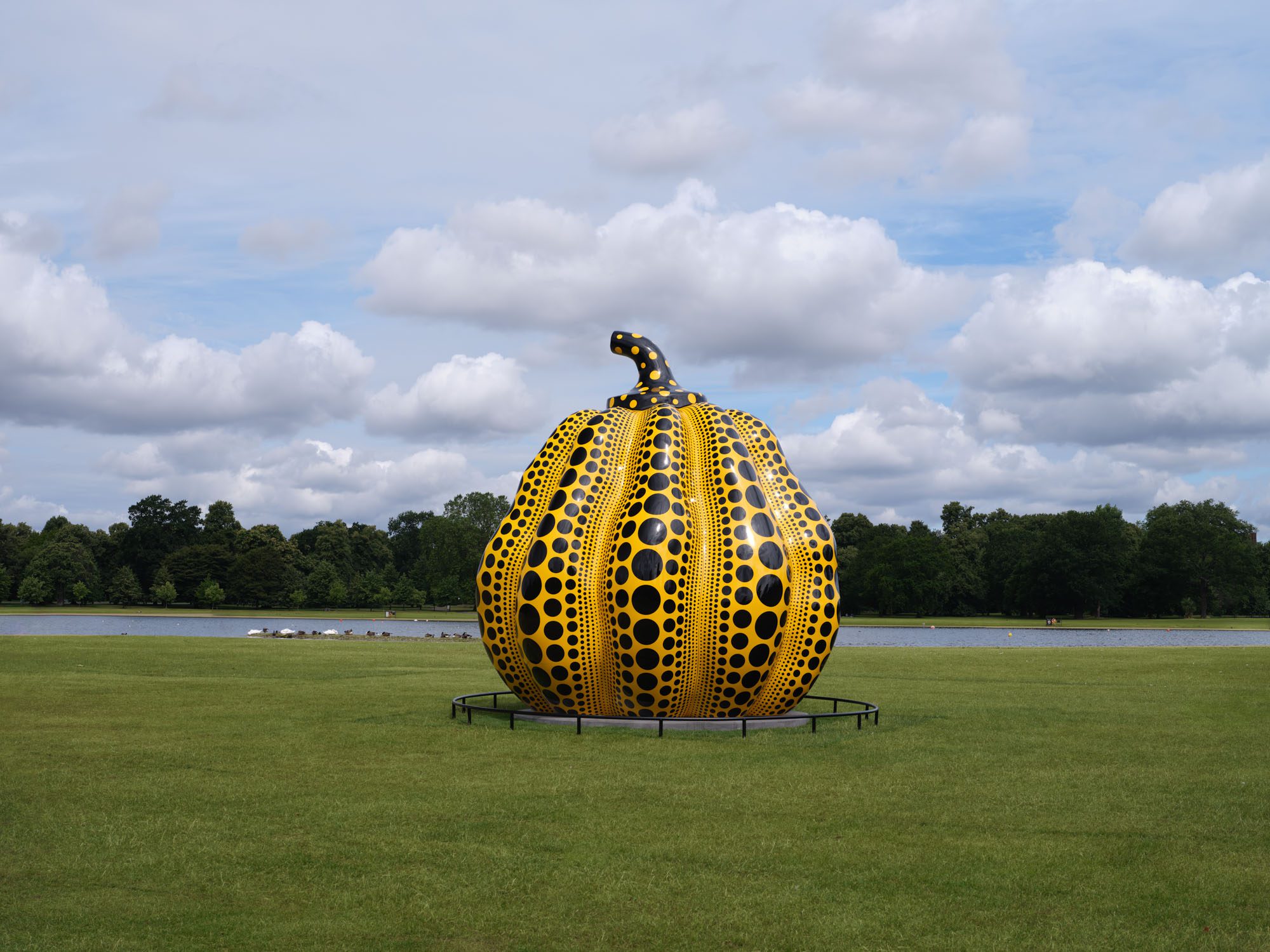 A bronze, six-meter-tall pumpkin painted yellow and orange.