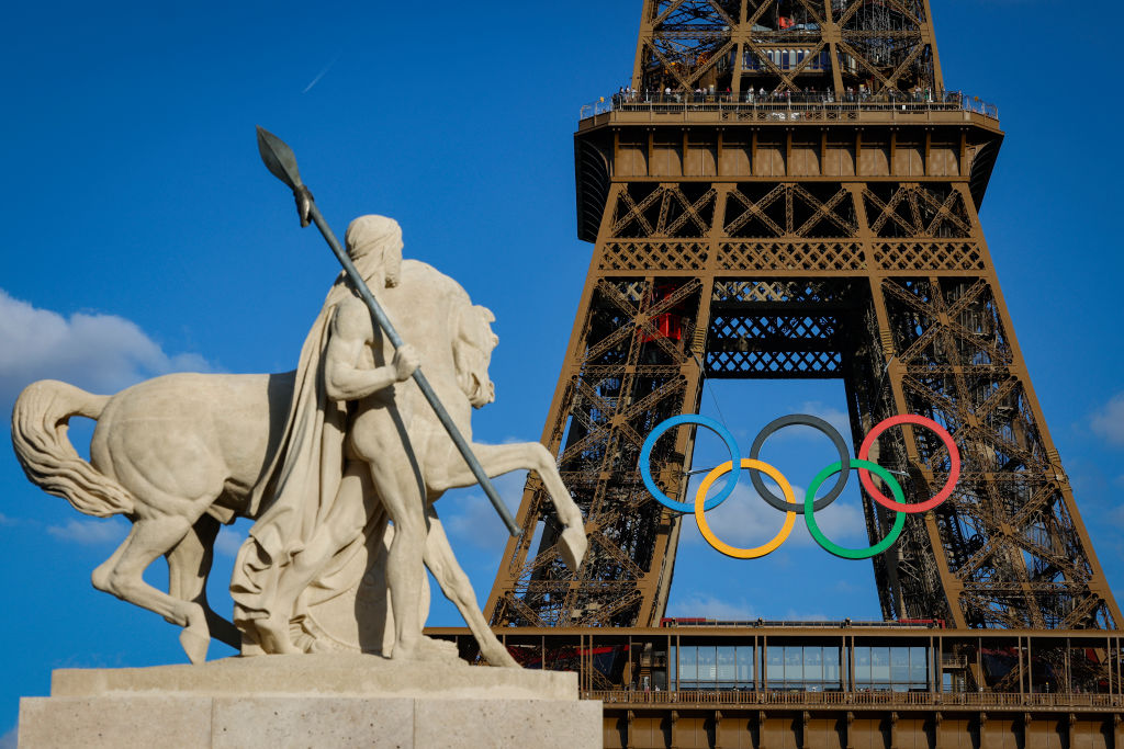 Olympic rings are seen on the Eiffel Tower near the restored statue of "Cavalier Arabe" (Arab rider) on the Pont d'Iena bridge in Paris on July 4, 2024, ahead of the upcoming Paris 2024 Olympic Games. (Photo by GEOFFROY VAN DER HASSELT / AFP) (Photo by GEOFFROY VAN DER HASSELT/AFP via Getty Images)