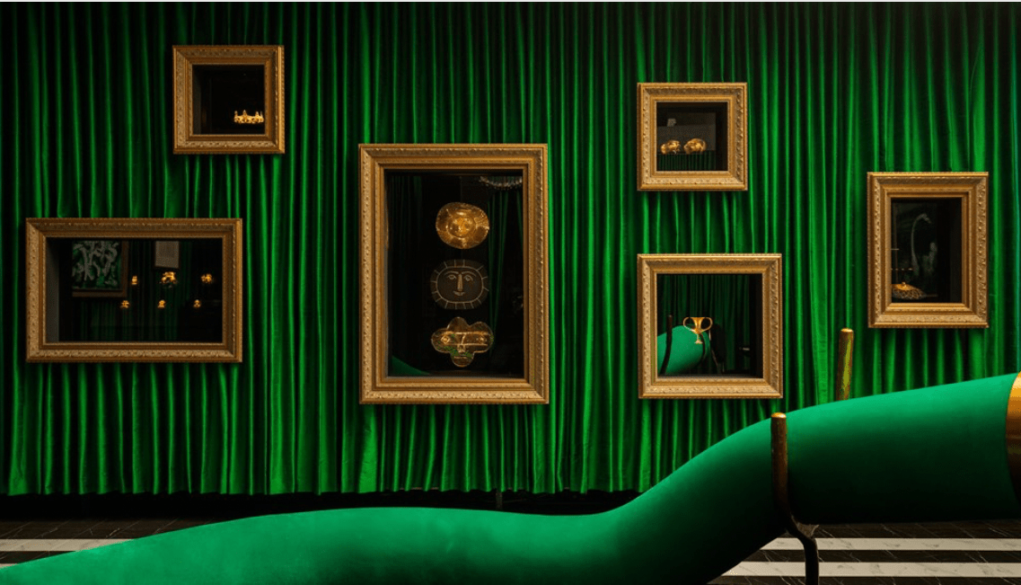 Artworks hang in a velvet-clad room.